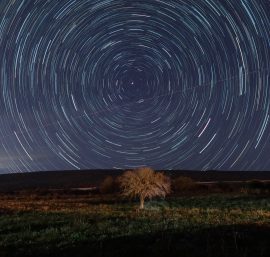 Through the Wormhole: Can Space-Time Enable Faster-Than-Light Travel?