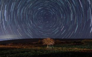 Through the Wormhole Can Space-Time Enable Faster-Than-Light Travel